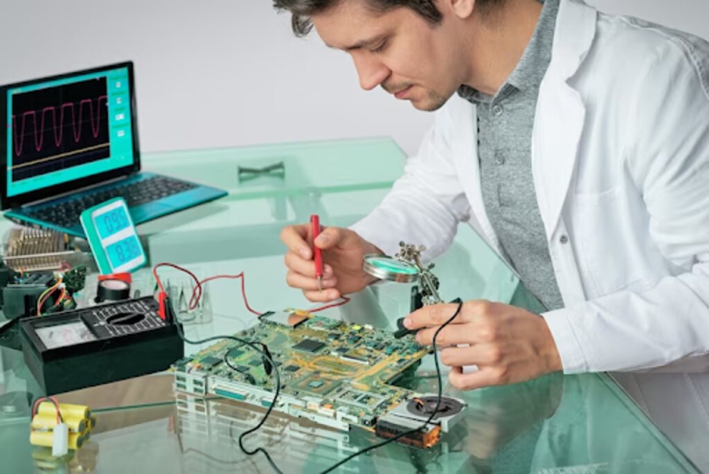 Young energetic male tech fixes electronic device